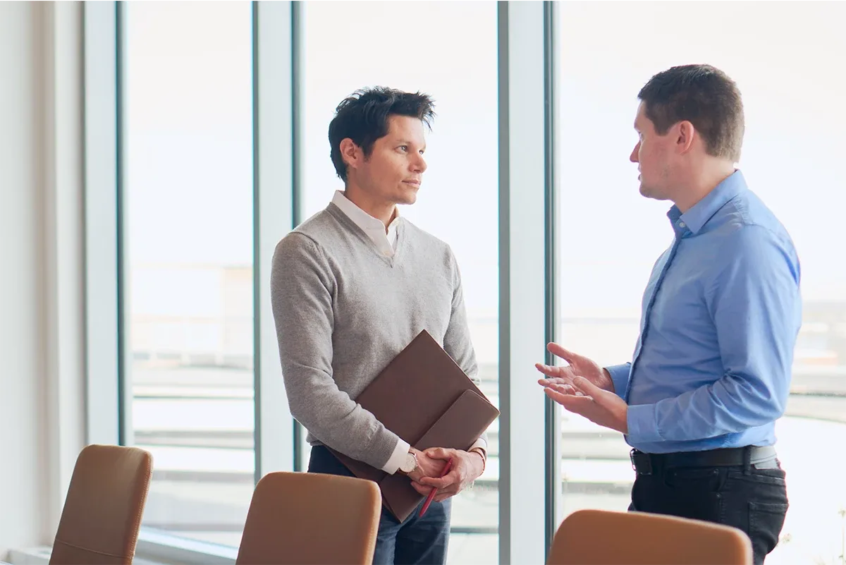 Coworkers talking after a meeting