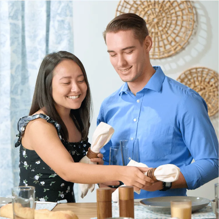 Couple setting the table for dinner